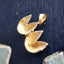 A stylish solid gold fortune cookie charm that can be opened. This charm has a3 dimensional design. Opened