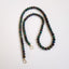 A bubble opal beaded necklace with two round loops at the ends. Available in black and white rounded smooth beads.
