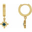 Gold hoop earrings with blue gemstones on a white background
