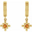 Gold earrings with orange gemstones on a white background