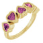 Gold ring with pink heart-shaped gemstones on a white background