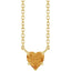 Gold necklace with a heart-shaped pendant on a white background