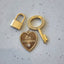 A gold padlock connector that has a spring push closure at the top. Works like a clasp and looks like a padlock.