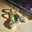 Solid gold green pear shaped tsavorite gemstone pendant with three baguette diamonds set at the bottom.