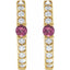 Gold earrings with pink gemstones and clear stones on a white background
