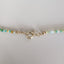 A rainbow colored opal strand beaded necklace made with gold filled wheel clasp.