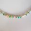 A rainbow colored opal strand beaded necklace made with gold filled wheel clasp.