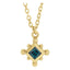 Gold necklace with a blue gemstone pendant on a white background