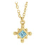 Gold necklace with a blue gemstone pendant on a white background