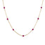 A solid gold station necklace with beaded gemstones evenly spaced out.