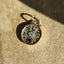 A beautiful coin charm with moon, lotus and flower vine designs, very detailed antique finish. With a round center diamond and carved stars.