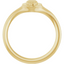An oval signet ring with a three dimensional skull set on its surface. This ring has a vintage vibe.