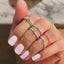 A thin band with colorful enamel and a center baguette stone. This ring is dainty and feminine.