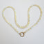 A bubble opal beaded necklace with two round loops at the ends. Available in black and white rounded smooth beads.