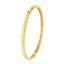 A gold bangle bracelet with ribbed square pattern. Very classic and looks best stacked.
