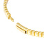 A gold bangle bracelet with ribbed square pattern. Very classic and looks best stacked.