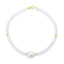 A faceted ombre beaded necklace with a large oval pearl in the center with two accent beads and round clasp.