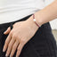 A faceted ombre beaded necklace with a large oval pearl in the center with two accent beads and round clasp.