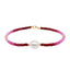 A faceted ombre beaded necklace with a large oval pearl in the center with two accent beads and round clasp.