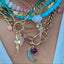 Product picture of the moon necklace with other pendant and beaded necklaces and chains.