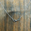 A sterling silver realistic hammer head shark pendant with a silver cable chain attached to the head and tail making it a lively necklace. Clasp