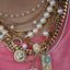 A pearl station necklace with fresh water pearls stationed with rolo link chain segments in between. Style