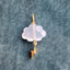 A storm cloud pendant with a hand carved gemstone and a solid gold charm attached at the bottom of the cloud.