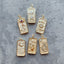 A tarot card inspired pendant with different face card designs such as love, rose, hourglass, the sun, the moon, the stars, and courage.