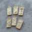 A tarot card inspired pendant with different face card designs such as love, rose, hourglass, the sun, the moon, the stars, and courage.