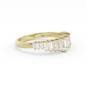 Gold ring with emerald-cut diamonds on a white background