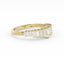 Gold ring with emerald-cut diamonds on a white background