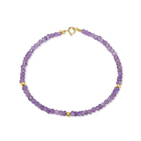 A faceted beaded gemstone bracelet with three gold bead accents and lobster clasp. Available in twelve natural gemstones. 
