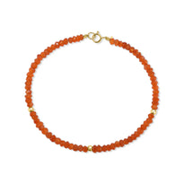 A faceted beaded gemstone bracelet with three gold bead accents and lobster clasp. Available in twelve natural gemstones. 