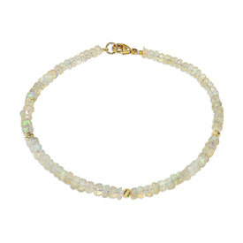 A faceted beaded gemstone bracelet with three gold bead accents and lobster clasp. Available in twelve natural gemstones. 