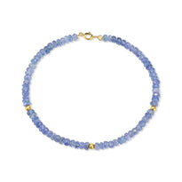 A faceted beaded gemstone bracelet with three gold bead accents and lobster clasp. Available in twelve natural gemstones. 