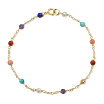 Multicolored beaded bracelet on a gold chain with a white background