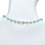 A blue gemstone beaded station necklace with yellow gold.