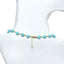 Turquoise beaded choker necklace on a mannequin with a white background