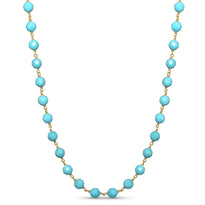 A blue gemstone beaded station necklace with yellow gold.