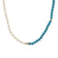 A beaded necklace with oval or bean shaped fresh water pearls and round blue turquoise beads. Finished with a round clasp.