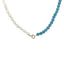 A beaded necklace with oval or bean shaped fresh water pearls and round blue turquoise beads. Finished with a round clasp.