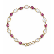 Gold necklace with pink and white gemstones on a white background