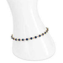 Gold bracelet with blue stones on a white mannequin wrist