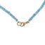 A faceted blue topaz beaded gemstone necklace with three pearls set evenly spaced in the front. Finished with a pear clasp. 