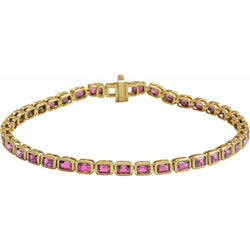 Gold bracelet with pink gemstones on a white background