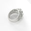 Silver ring with intricate design on a white background