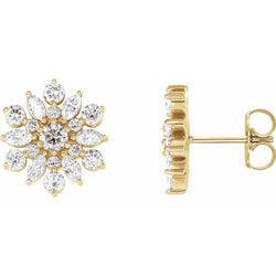 Gold earrings with diamond-like stones on a white background