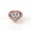 Heart-shaped diamond ring with rose gold setting on a white background