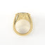 Gold ring with a white stone on a white background