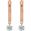 Rose gold earrings with clear gemstones on a white background